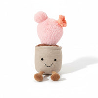 Kuscheltier Kawaii-Pflanze Kaktus rosa im lächelnden Topf mit kleiner Blüte