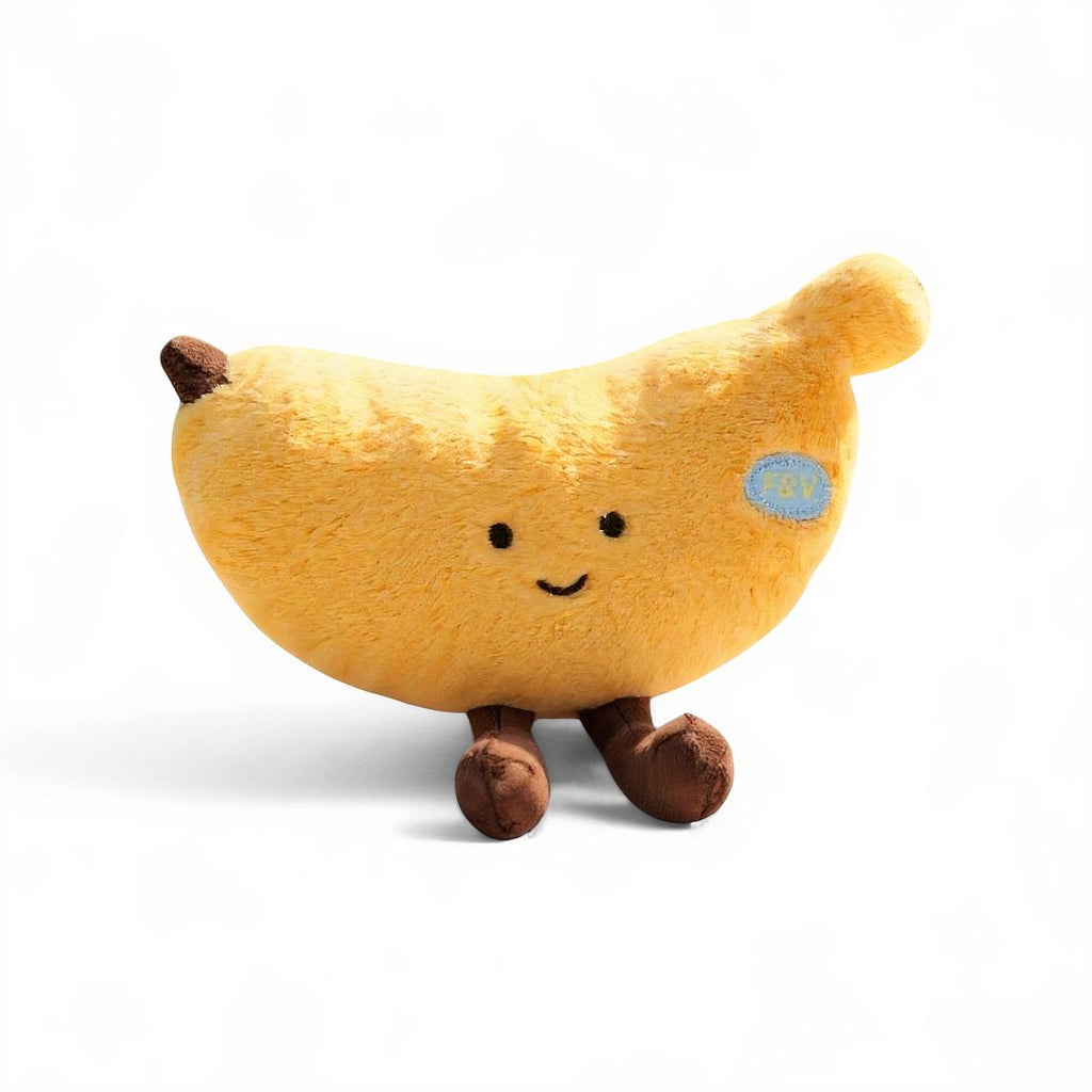 Gelbes Bananen-Kuscheltier mit lächelndem Gesicht und braunen Beinchen, auf weißem Hintergrund.