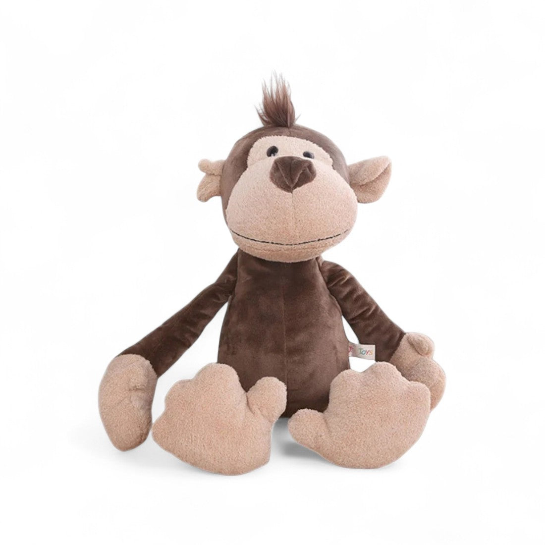Braunes Affen-Kuscheltier, beige Schnauze, Haarschopf auf dem Kopf, große flauschige Füße und Hände, treuherziges Lächeln, sitzend auf weißem Hintergrund.