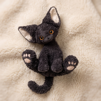 Lockiges schwarzes Katze Kuscheltier - Detailansicht Material