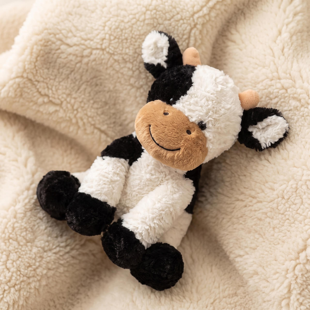 Schwarz-weiße weiche Kuh Kuscheltier - Detail Material
